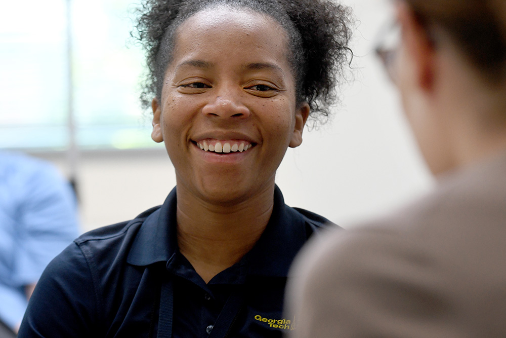 Astudent working with a Mentor laughing together